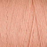 Close-up of soft, pale pink Cotton Carpet Warp 8/4 yarn with a uniform pattern. The colorfast texture features smooth strands and slight hue variations, offering a subtle, natural look similar to cotton warp yarn used for crafting rag rugs.