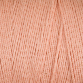 Close-up of soft, pale pink Cotton Carpet Warp 8/4 yarn with a uniform pattern. The colorfast texture features smooth strands and slight hue variations, offering a subtle, natural look similar to cotton warp yarn used for crafting rag rugs.