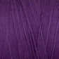 A close-up of the Cotton Carpet Warp 8/4 reveals soft, purple fibers resembling wool, weaving together like rag rugs to form a dense, fuzzy texture.