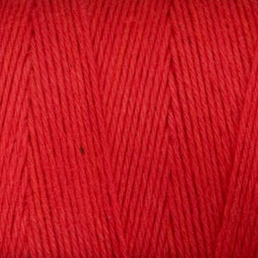 Close-up of Cotton Carpet Warp 8/4 reveals its soft texture and tightly twisted fibers, ideal for rag rugs. The vibrant, colorfast strands display a uniform hue with a diagonal pattern perfect for cotton warp yarn projects.