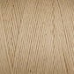 Close-up of Cotton Carpet Warp 8/4 yarn, cream-colored with visible texture and tightly wound strands. The uniform hue suggests it may be ideal for knitting or crocheting projects like rag rugs.