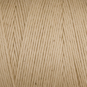 Close-up of Cotton Carpet Warp 8/4 yarn, cream-colored with visible texture and tightly wound strands. The uniform hue suggests it may be ideal for knitting or crocheting projects like rag rugs.