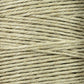 A close-up of a spool of beige twine displays tightly wound fibers, similar to Soft Finish Linen Warps used in tapestry weaving. Its coarse, natural texture and visible horizontal strands echo the craftsmanship found in Scandinavian rug creation.