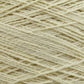 Close-up of a ball of Worsted Wool Warps by Jagger Brothers, Inc. The cream-colored fibers are loosely wound and exhibit a slightly textured appearance, highlighting various individual strands interwoven. This soft yarn, ideal for Navajo designs or other weft-face projects, is perfect for knitting or crocheting endeavors.