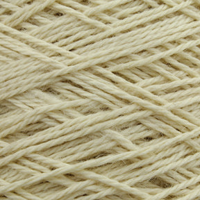 The close-up of the off-white Worsted Wool Warps by Jagger Brothers, Inc. showcases the individual fibers and intertwined strands. The texture is soft, featuring a uniform yet slightly irregular pattern, reminiscent of materials used in weft-face projects.