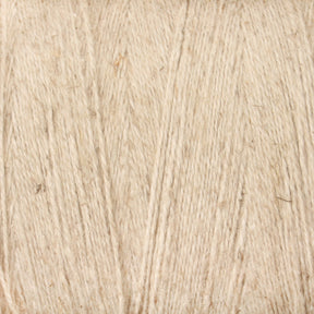 A close-up image of Maurice Brassard's 8/2 Cottolin Organic Yarn, highlighting the exquisite detail of the texture and fibers in beige. The yarn, a cotton-linen blend with a surface that showcases subtle variations in color and thickness, is reminiscent of the fibers used in a Cottolin Tea Towel Kit.