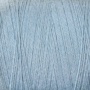 Close-up of a light blue Maurice Brassard 8/2 Cottolin Organic Yarn, showcasing fine and soft strands tightly wound together. The texture features a subtle sheen, giving it a slightly glossy appearance. Made from a cotton linen blend, the yarn's hue appears uniform throughout the image.