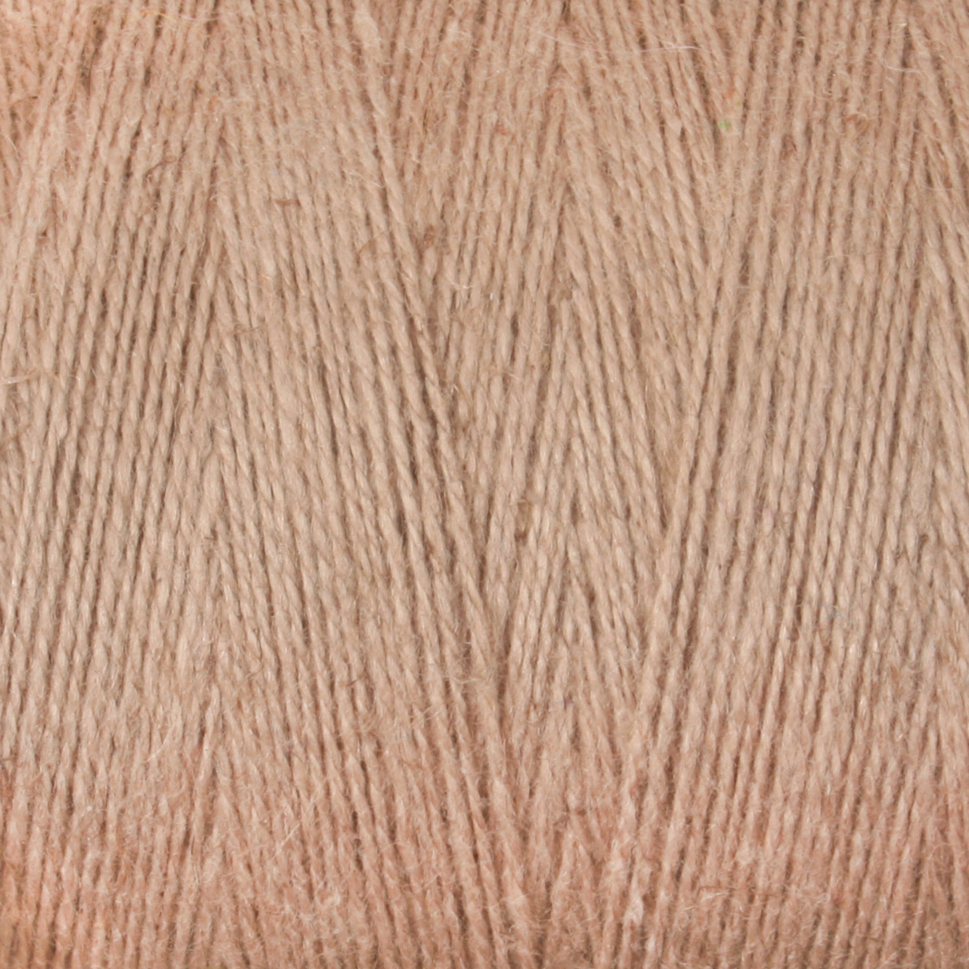 Close-up of beige-colored Maurice Brassard 8/2 Cottolin Organic Yarn on a tube. The cotton-linen blend is tightly wound, showcasing the fibers and texture in detail. The neutral, pale beige color provides a soft and warm appearance, ideal for projects on a four shaft loom.