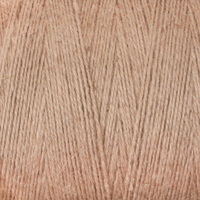 Close-up of beige-colored Maurice Brassard 8/2 Cottolin Organic Yarn on a tube. The cotton-linen blend is tightly wound, showcasing the fibers and texture in detail. The neutral, pale beige color provides a soft and warm appearance, ideal for projects on a four shaft loom.