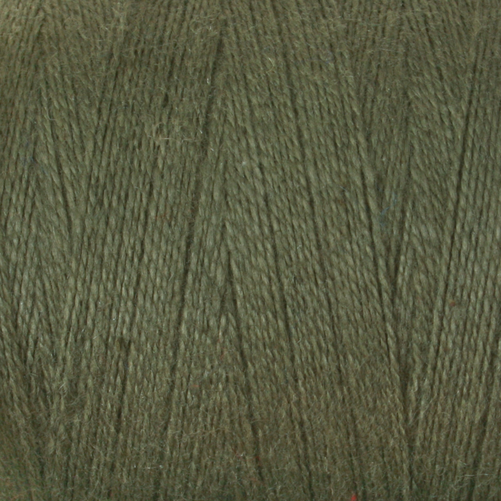 Close-up of Maurice Brassard's 8/2 Cottolin Organic Yarn, showing the fibers and texture of the material. The yarn is tightly wound, and the image highlights the intricate details of the strands, giving a sense of the thread's thickness and composition—perfect for projects like a Cottolin Tea Towel Kit on a four-shaft loom.