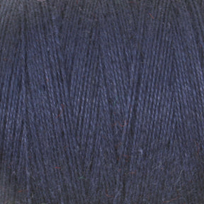 A close-up view of the Maurice Brassard 8/2 Cottolin Organic Yarn in dark blue, showcasing its tightly spun fibers and subtle texture. The cotton linen blend appears soft and slightly fuzzy, making it ideal for knitting or crocheting projects.