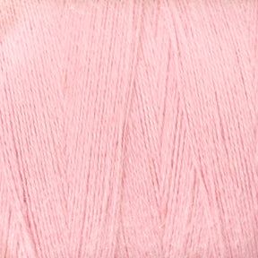 A close-up image of a ball of Maurice Brassard's 8/2 Cottolin Organic Yarn | Tube in light pastel pink. The yarn appears soft and finely woven, with a consistent and smooth texture, giving it a gentle and delicate appearance—perfect for use in the Cottolin Tea Towel Kit on your four shaft loom.