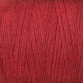 Close-up shot of tightly wound 8/2 Cottolin Organic Yarn from Maurice Brassard, showcasing its vibrant red color and soft texture. The detailed image highlights the individual strands and slight variations in the hue, with a uniform crisscross pattern reminiscent of those created on a four shaft loom.