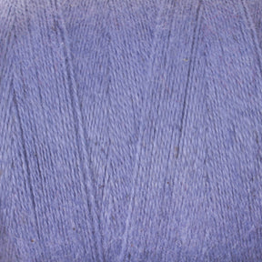 Close-up image of a ball of 8/2 Cottolin Organic Yarn from Maurice Brassard, showcasing the light purple fibers and texture in intricate detail. The tightly wound strands form a smooth and consistent surface, perfect for knitting or crocheting projects like those found in the cozy cotton linen blend Cottolin Tea Towel Kit.