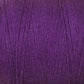 A close-up view of a spool of 8/2 Cottolin Organic Yarn from Maurice Brassard. The texture of the cotton linen blend yarn is clearly visible, with tightly wound fibers creating a consistent pattern. The color is rich and vibrant, showcasing various shades of deep purple under the light, making it perfect for your four shaft loom project.