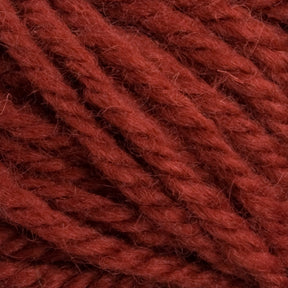 Close-up image of thick, twisted strands of Halcyon Yarn Classic Rug Wool | Strand by Caledonian Dye Works. The texture is soft and fibrous, with interwoven fibers creating a cozy, dense appearance. The rich maroon color is uniform, reminiscent of classic rug wool hand-dyed by skilled rug weavers, giving a warm and inviting feel.