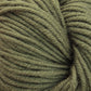 Close-up shot of a bundle of Plymouth Select Worsted Merino Superwash yarn by Plymouth Yarn Co. The yarn, made from superwash merino, is tightly wound and has a slightly fuzzy texture with individual strands clearly visible. Its muted, earthy green color gives the yarn a natural appearance and excellent stitch definition.