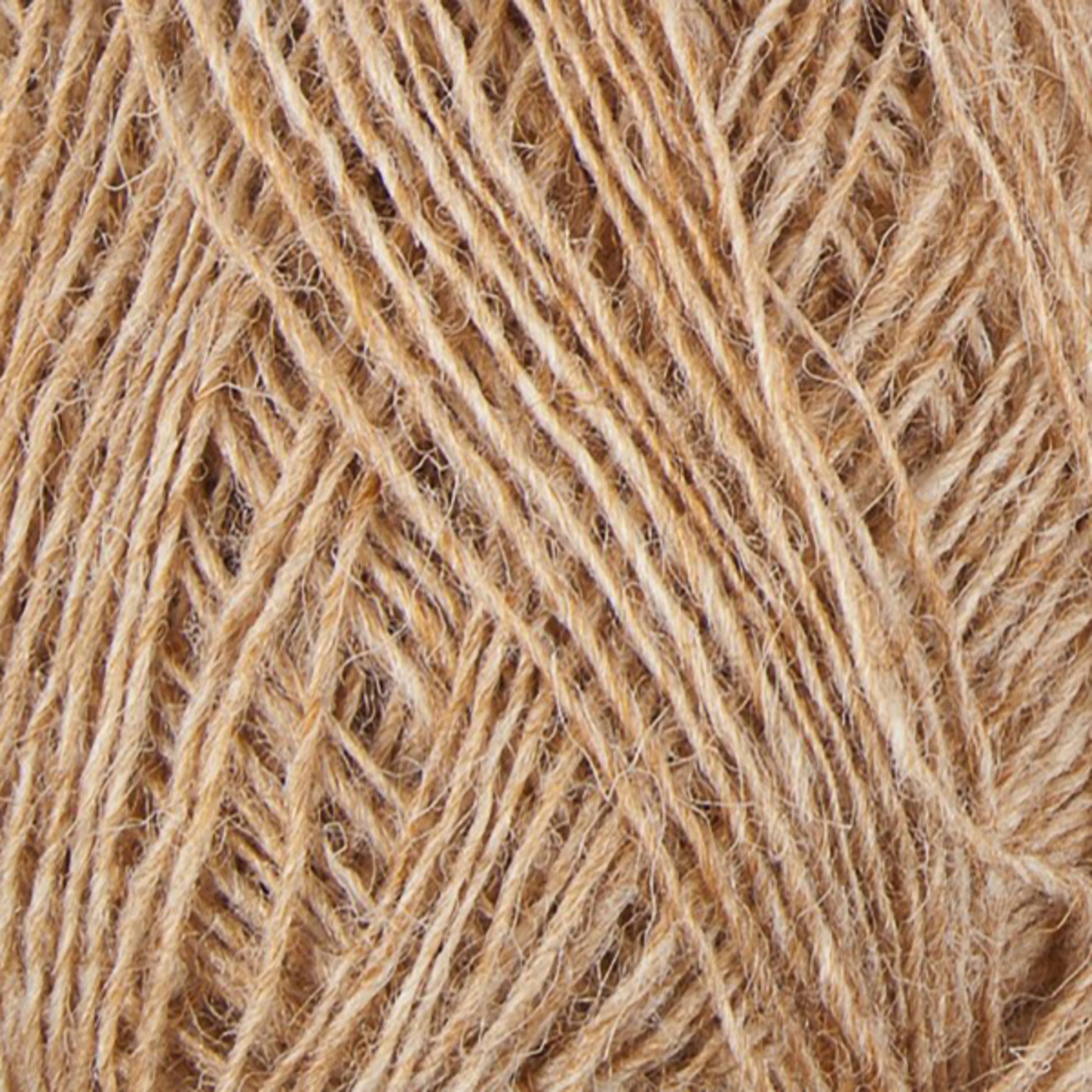 Close-up view of a ball of Beige Einband Lopi yarn by Berroco, Inc., with fibers tightly wound together. The texture is clearly visible, showcasing individual strands twisted into a thicker cord. The slightly rough appearance suggests it may be Icelandic wool or another natural fiber like jute, making it perfect for intricate lace knitting projects.