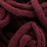 Close-up image of knotted, bulky Harrisville Potholder Loops from the Friendly Loom range, showcasing their detailed texture and interwoven threads. The image highlights the dense, coarse weave of the maroon material reminiscent of traditional loom craftsmanship.