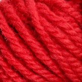 Close-up of a skein of Halcyon Yarn Classic Rug Wool | Strand in bright red, with thick, soft strands tightly intertwined. The texture appears fluffy and slightly fuzzy, showcasing the cozy and warm nature that rug weavers cherish in their hand-dyed materials from Caledonian Dye Works.