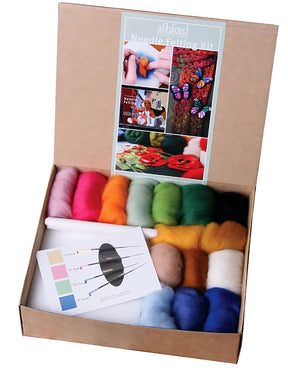 An Ashford Needle Felting Kit from Ashford Handicrafts Limited is open. The colorful wool is neatly arranged in the box, along with a booklet and a card showing different needles. The box label reads "Ashford Needle Felting Kit" and features images of completed projects.