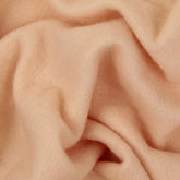 Close-up of soft, crumpled Merino Prefelt by Europa Wools Ltd, featuring a slightly fuzzy texture that creates gentle folds and shadows.