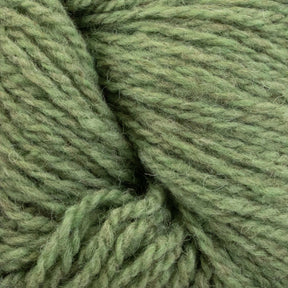 A close-up view of a skein of Patagonia Organic Merino by Juniper Moon Farm from Knitting Fever / Euro Yarns. The yarn, crafted from Organic Merino Wool, appears soft and slightly fuzzy, with twisted strands showcasing its texture. Its green color is uniform with slight variations, giving it a natural, organic look.