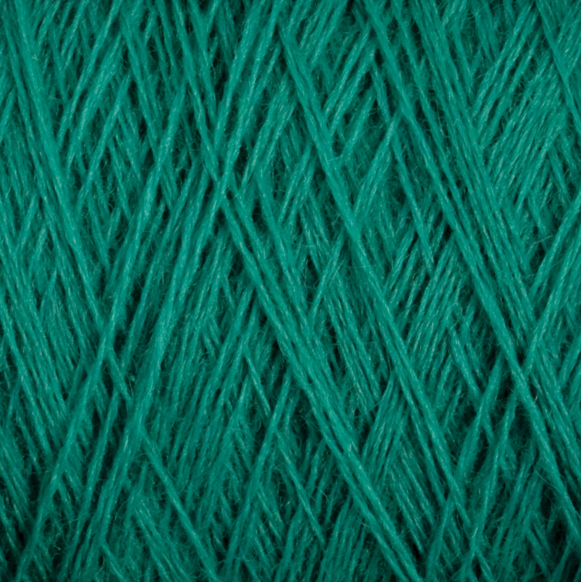 Close-up view of tightly woven turquoise yarn, displaying a crisscross pattern of the threads. The texture is soft, with the strands running diagonally in different directions. Crafted from premium JaggerSpun Maine Line 2/20 Yarn by Jagger Brothers, Inc., this medium-grade wool ensures both durability and comfort.