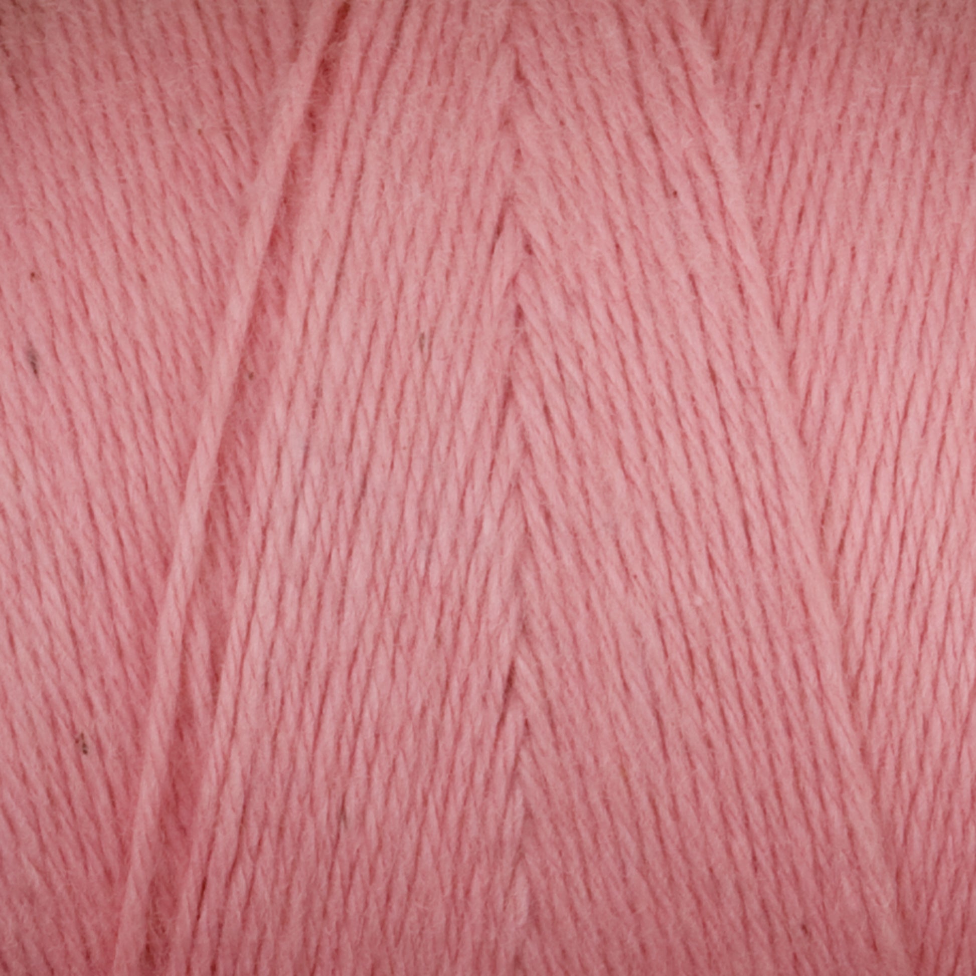 Close-up of a ball of Maurice Brassard's Medium Cotton 16/8 Mop Yarn in pink, showing the tightly wound strands with a slight sheen. The texture appears soft and smooth, suitable for knitting or crocheting projects. Made from sturdy cotton, the image highlights the detailed fibers and even color, perfect for both weaving and crafting endeavors.