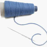 A blue thread cone with loose thread extending, accompanied by a Lacis Big Eye Needle for Beading threading part of the loose thread. The coiled thread gently curves next to the needle on a plain, light-colored background, resembling the delicate start of knitting with beads.