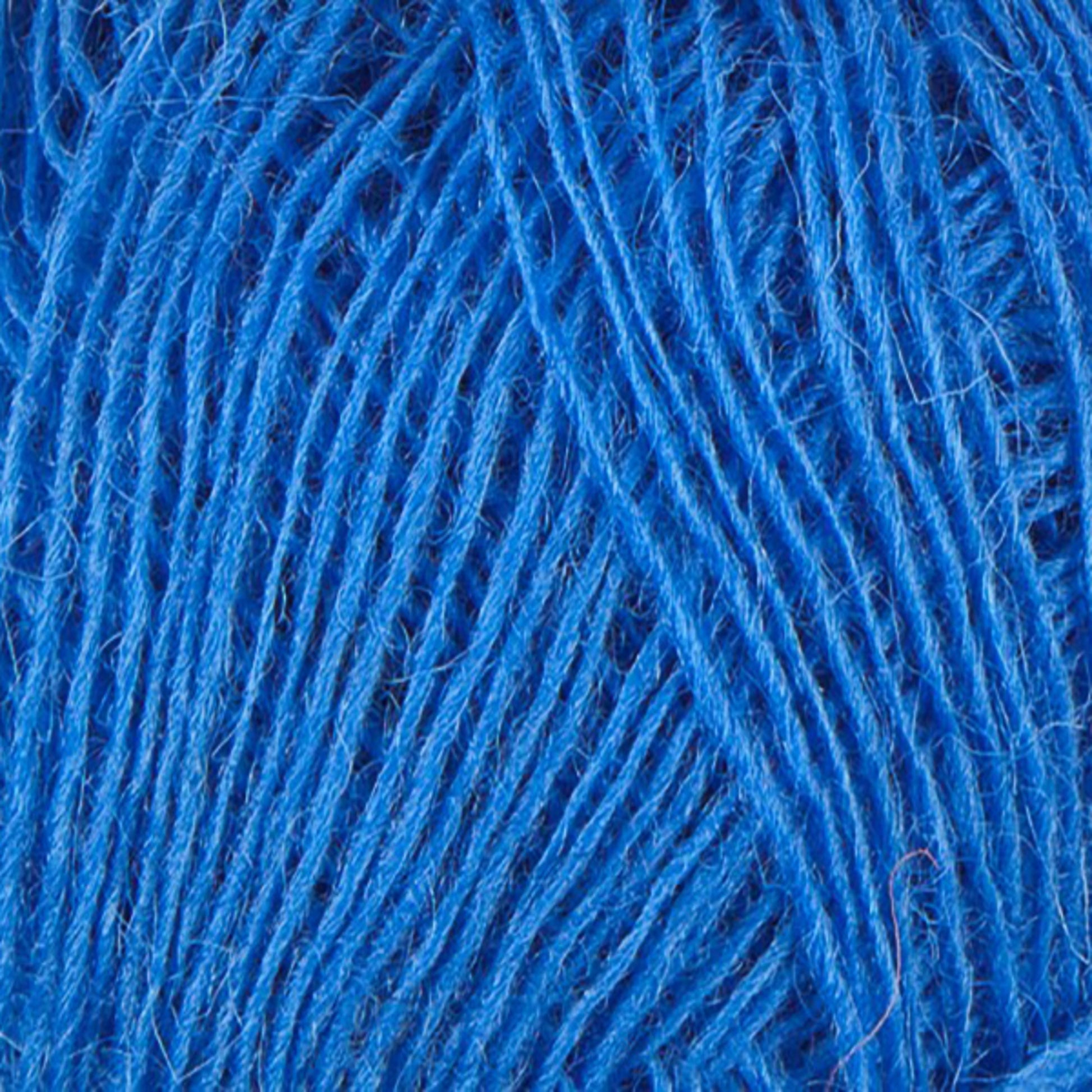 In this close-up image of tangled Einband Lopi yarn, the bright blue fibers showcase the intricate weave and texture. The vibrant Icelandic wool from Berroco, Inc. appears slightly fuzzy, with overlapping strands forming an intertwined pattern ideal for stranded colorwork.