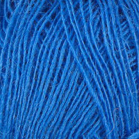 In this close-up image of tangled Einband Lopi yarn, the bright blue fibers showcase the intricate weave and texture. The vibrant Icelandic wool from Berroco, Inc. appears slightly fuzzy, with overlapping strands forming an intertwined pattern ideal for stranded colorwork.