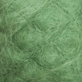 Close-up image of green-colored fibers, creating a textured surface with intricate patterns and overlapping strands. The appearance is soft and dense, reminiscent of the luxurious Victorian Brushed Mohair Yarn from Caledonian Dye Works, giving a sensation of natural material or artfully crafted Halcyon Yarn supplies.