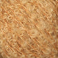 Close-up of a skein of soft, curly yarn from Caledonian Dye Works' Victorian Bouclé Mohair Yarn in a warm, light golden color. The yarn has a fuzzy, textured appearance with tightly wound curls and strands running through it.