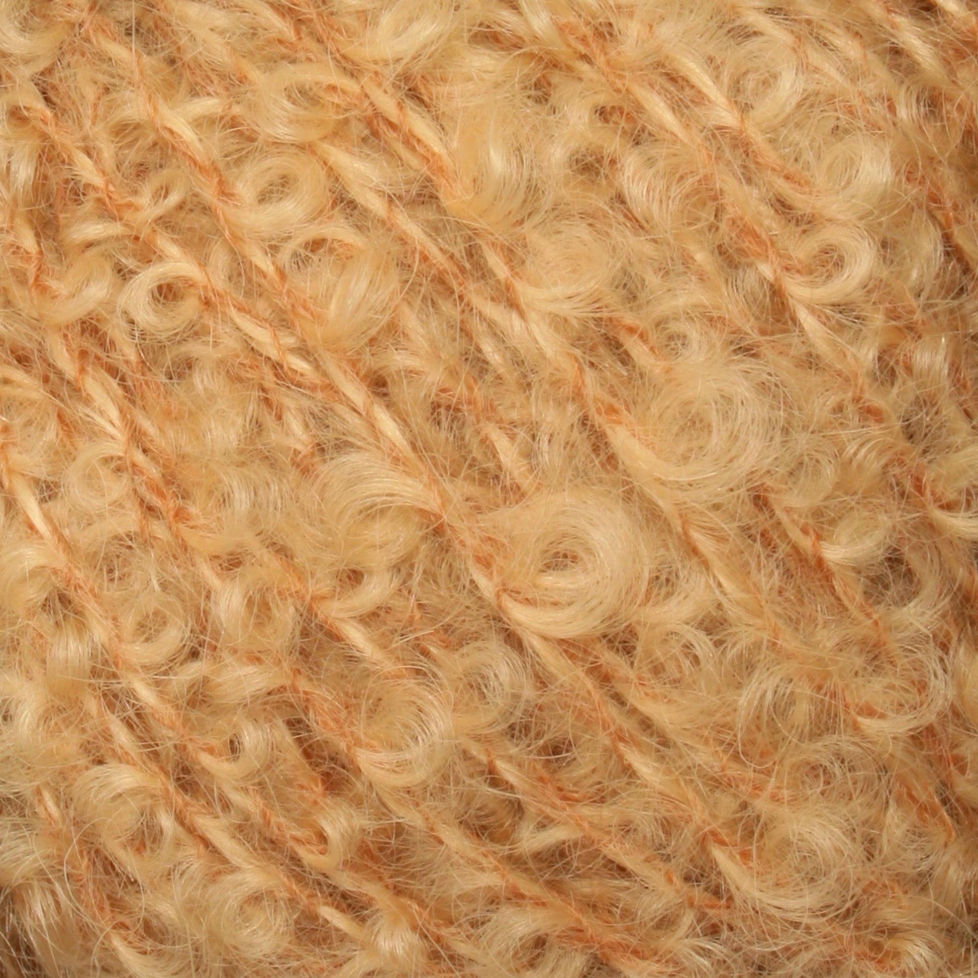 Close-up of a skein of soft, curly yarn from Caledonian Dye Works' Victorian Bouclé Mohair Yarn in a warm, light golden color. The yarn has a fuzzy, textured appearance with tightly wound curls and strands running through it.