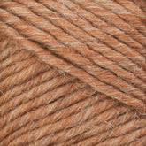 Close-up image of a skein of Lamb's Pride Bulky Yarn by Brown Sheep in a blended color of rust and beige. The individual fibers and twist of the yarn are clearly visible, highlighting its texture and thickness, perfect for knitters and crocheters creating Icelandic sweaters.