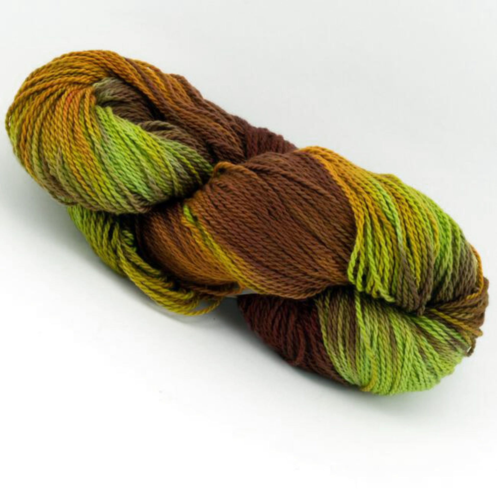 A skein of Great Adirondack Organic DK Cotton by Great Adirondack Yarn Co., Inc., showcasing hand-dyed, multicolored hues with shades of green, yellow, brown, and hints of orange, tightly coiled together and resting against a white background.