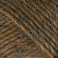 Close-up image of Lamb's Pride Bulky Yarn by Brown Sheep, featuring brown yarn with intertwined fibers. The yarn boasts a textured appearance with a blend of dark and light brown strands, creating a rich, natural look. Perfect for knitters and crocheters, the tightly spun fibers showcase exquisite details suitable for woven blankets or Icelandic sweaters.