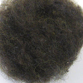 A close-up image of a dense, dark brown, and tightly curled hairball, possibly resembling a clump of curly Harrisville Designs Harrisville Dyed & Carded Wool Fiber against a plain white background.