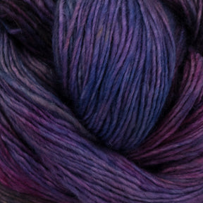 Close-up image of a skein of soft, multi-colored Malabrigo Lace yarn from Malabrigo Yarn. The yarn features a blend of rich, deep hues including purples, blues, and hints of pink. The fibers look thick and plush, making it ideal for knitting or crocheting cozy garments like knitted shawls or accessories.