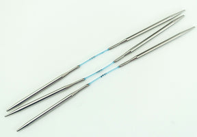 Two sets of Skacel Addi FlexiFlips Circular Needles, ideal for knitting socks, are connected by blue, flexible cables and arranged parallel to each other on a white background. These circular needles are smooth and taper to fine points.