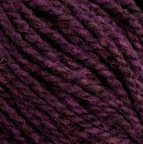 Close-up image of dark purple Harrisville Highland - Cones yarn by Harrisville Designs. The fibers are tightly twisted, exhibiting a slightly fuzzy texture. The various shades of purple create a rich, multidimensional appearance, further enhanced by the hint of spinning oils still present in this unscoured yarn.