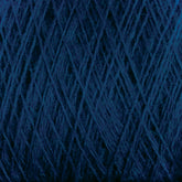 Close-up of a ball of dark blue Jagger Brothers, Inc. JaggerSpun Maine Line 3/8 Yarn | Mini-cone, showing intricate and overlapping strands. The texture is thick and fibrous, with the dark hue dominating the image. The image captures the complexity and detail of this Maine wool yarn's weave and material.