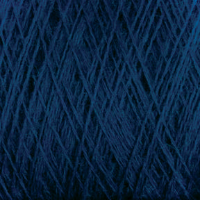 Close-up of a ball of dark blue Jagger Brothers, Inc. JaggerSpun Maine Line 3/8 Yarn | Mini-cone, showing intricate and overlapping strands. The texture is thick and fibrous, with the dark hue dominating the image. The image captures the complexity and detail of this Maine wool yarn's weave and material.