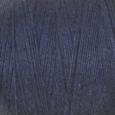 Close-up of dark blue 8/2 Cottolin Organic Yarn from Maurice Brassard. The yarn fibers are tightly spun, displaying a smooth and consistent texture with a few subtle specks of other colors.