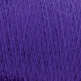 A close-up image of JaggerSpun Maine Line 3/8 Yarn in a mini-cone, showcasing its fine texture and slightly fuzzy appearance. The strands are tightly wound together, creating a dense and rich purple hue characteristic of Jagger Brothers, Inc. yarns.