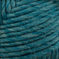 Close-up of Brown Sheep's Lamb's Pride Bulky Yarn in teal, showcasing its texture and fibers tightly wound into a ball. The strands appear soft and slightly fuzzy, with varying shades of teal creating a marbled effect perfect for knitters and crocheters dreaming up their next Icelandic sweaters.