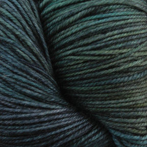 Close-up image of Malabrigo Yarn's dark green and black kettle dyed multicolored yarn, specifically their *Malabrigo Sock* line, showcasing its texture and intricately twisted strands. The colors blend seamlessly, highlighting the natural sheen and smoothness of the merino wool fiber.