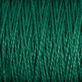 Close-up image of green 10/2 Pearl Cotton Yarn | Mini-cone strands from Supreme Corp., tightly wound together, creating a textured, interwoven pattern that showcases the material's versatile nature and impressive colorfastness.