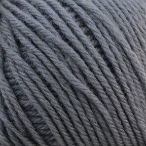 Close-up image of a ball of Baby Blatt by Anny Blatt gray baby yarn with thick strands. The texture of the yarn is visible, showcasing its soft and slightly fuzzy appearance, suitable for knitting or crocheting projects. This machine washable yarn from Essentially Felt Studio & Fine Yarn ensures both convenience and comfort for all your creations.